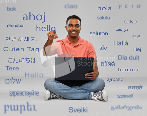 Image of happy indian man with laptop learning languages