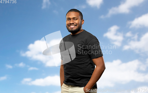 Image of smiling african american man over blue sky