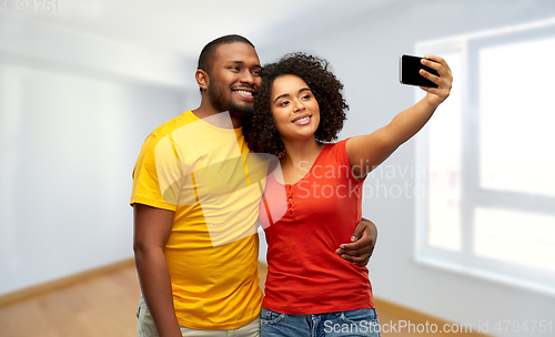Image of african american couple takes selfie by smartphone