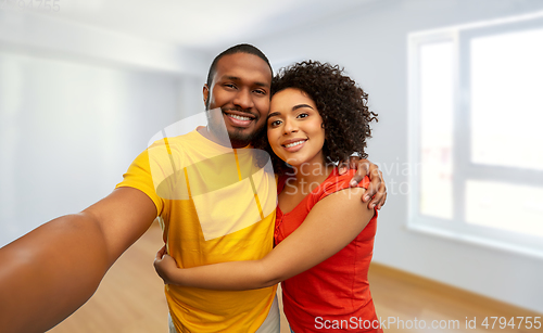 Image of happy smiling african american couple takes selfie