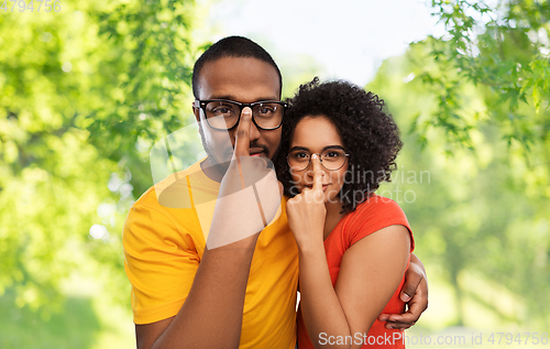 Image of happy african american couple in glasses hugging