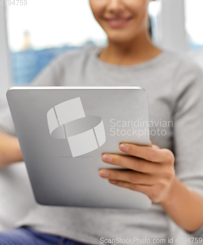 Image of close up of woman with tablet pc computer at home