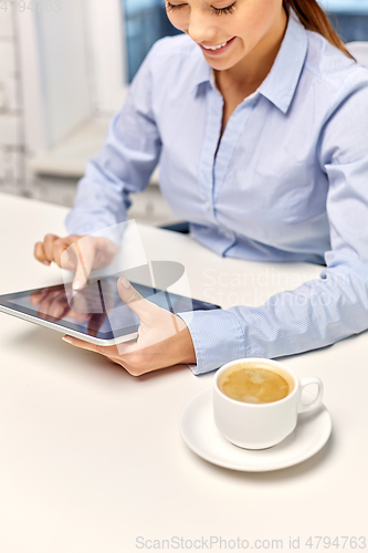 Image of businesswoman with tablet pc and coffee at office