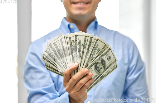 Image of smiling businessman with american dollar money