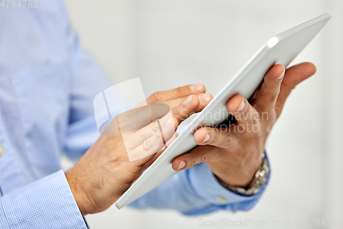 Image of close up of male hands with tablet pc computer