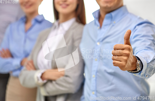 Image of close up of happy businessman showing thumbs up