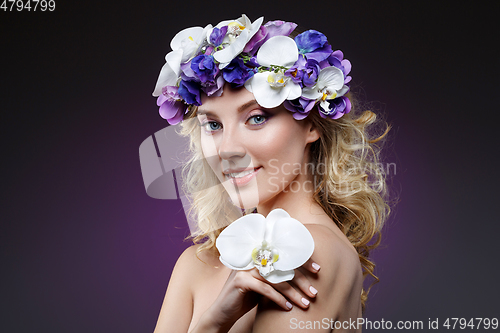 Image of beautiful blond girl with flowers