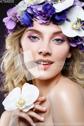 Image of beautiful blond girl with flowers