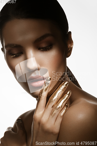 Image of girl with golden paint on fingers