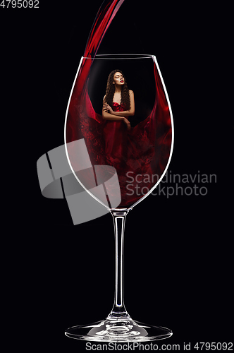 Image of girl in red dress inside wine glass