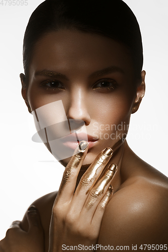 Image of girl with golden paint on fingers