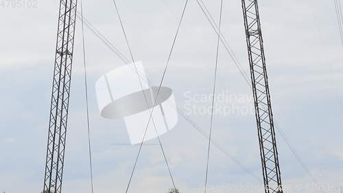 Image of Cloudy morning sky and a high-voltage line