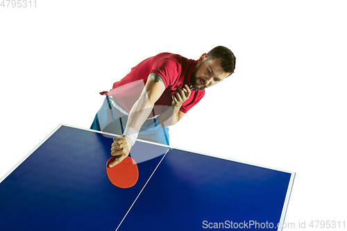 Image of Young man playing table tennis on white studio background