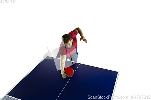 Image of Young man playing table tennis on white studio background