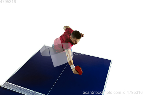 Image of Young man playing table tennis on white studio background