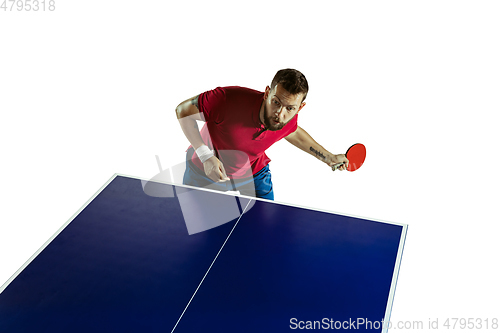 Image of Young man playing table tennis on white studio background