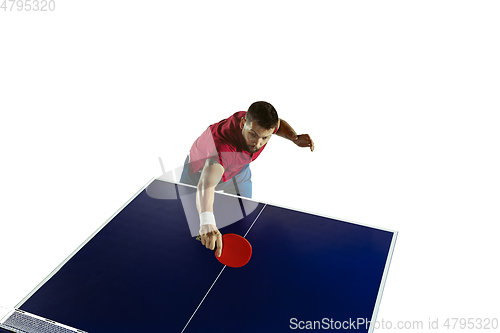 Image of Young man playing table tennis on white studio background