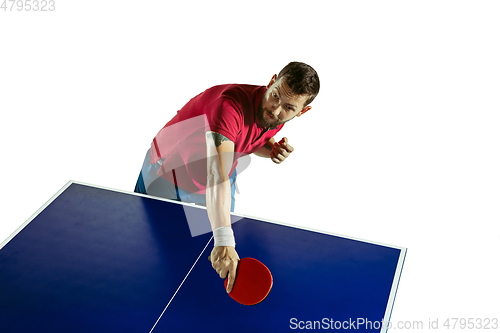 Image of Young man playing table tennis on white studio background