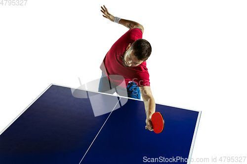 Image of Young man playing table tennis on white studio background