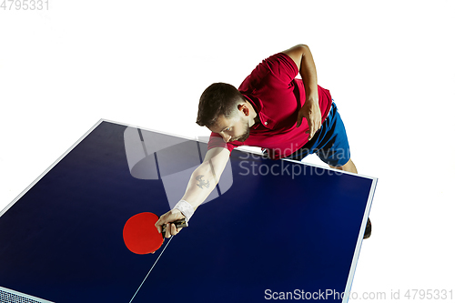 Image of Young man playing table tennis on white studio background