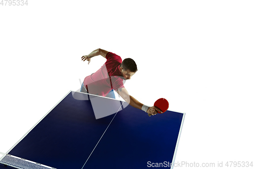 Image of Young man playing table tennis on white studio background