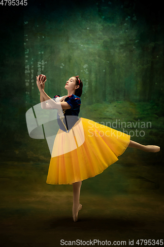 Image of Young ballet dancer as a Snow White with poisoned apple in forest