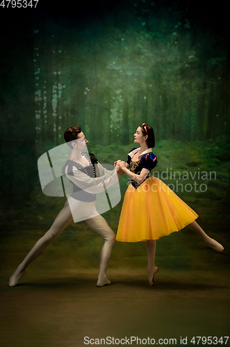 Image of Young ballet dancers as a Snow White\'s characters in forest