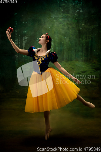 Image of Young ballet dancer as a Snow White with poisoned apple in forest