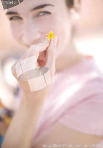 Image of woman holding flower