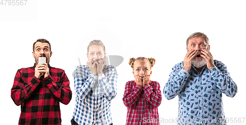 Image of Family members with one another on white studio background.