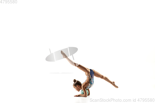 Image of Little flexible female gymnast isolated on white studio background