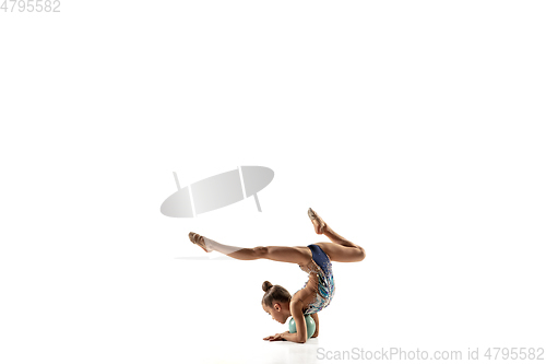 Image of Little flexible female gymnast isolated on white studio background