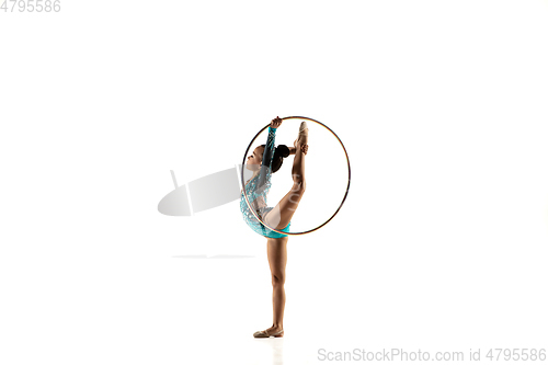 Image of Little flexible female gymnast isolated on white studio background