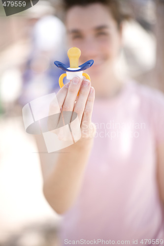 Image of woman holding pacifier