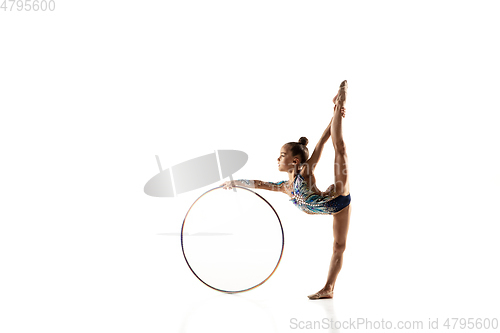 Image of Little flexible female gymnast isolated on white studio background