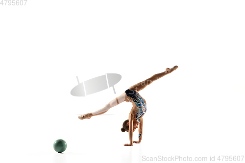 Image of Little flexible female gymnast isolated on white studio background