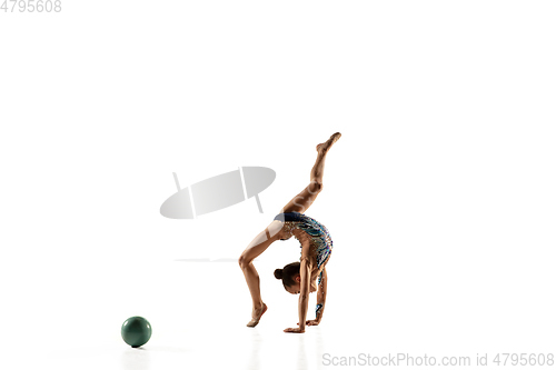 Image of Little flexible female gymnast isolated on white studio background