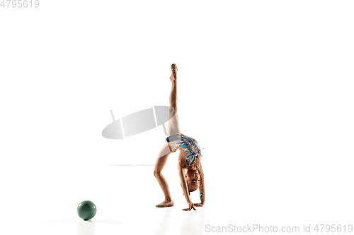 Image of Little flexible female gymnast isolated on white studio background