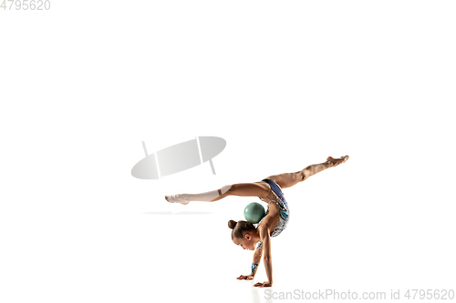 Image of Little flexible female gymnast isolated on white studio background