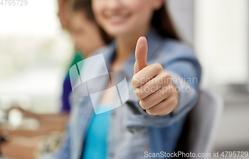 Image of close up of happy student girl showing thumbs up