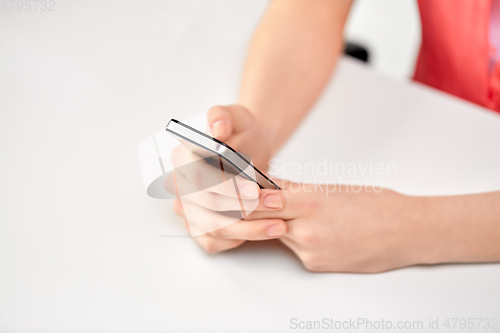 Image of close up of female hands with smartphone