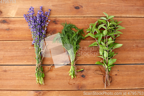 Image of lavender, dill and peppermint on wooden background