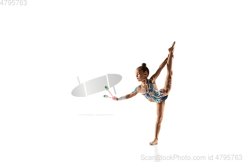 Image of Little flexible female gymnast isolated on white studio background