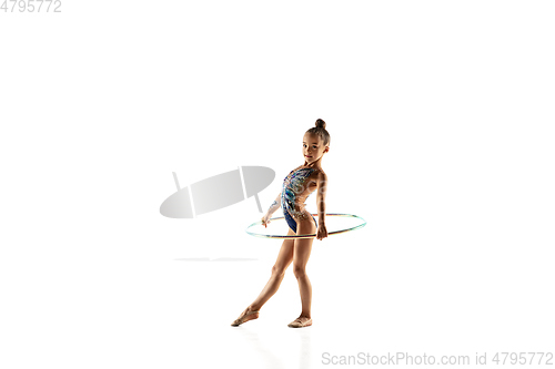 Image of Little flexible female gymnast isolated on white studio background