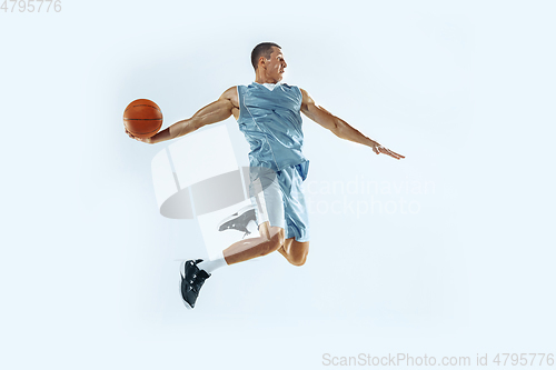 Image of Young caucasian basketball player against white studio background