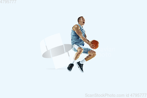 Image of Young caucasian basketball player against white studio background