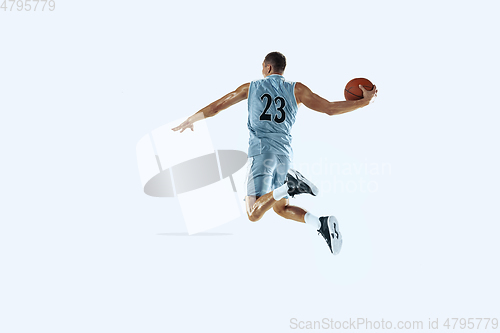 Image of Young caucasian basketball player against white studio background