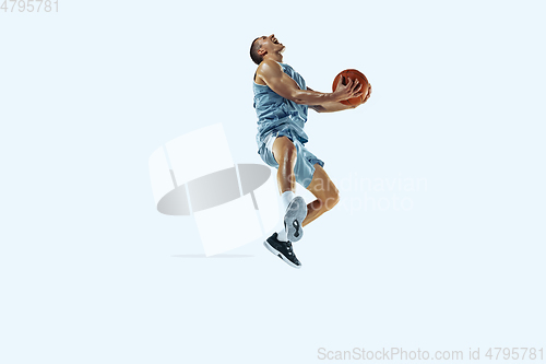 Image of Young caucasian basketball player against white studio background