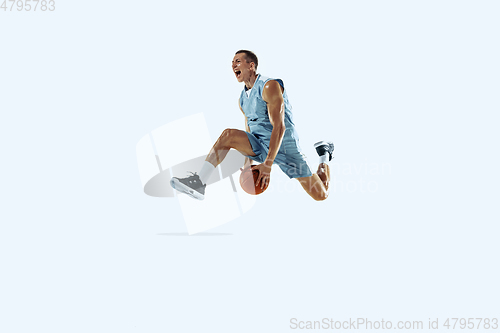 Image of Young caucasian basketball player against white studio background