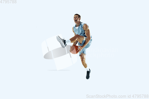 Image of Young caucasian basketball player against white studio background
